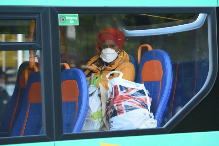A woman rides a nearly empty bus in Manchester, June 2020