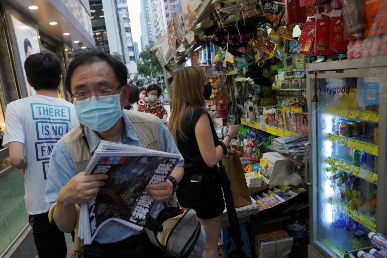 Hong Kong citizens line up to buy the final edition of Apple Daily