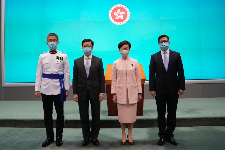 Hong Kong Chief Executive Carrie Lam Cheng Yuet-ngor (second from right) poses for a photo with Chief Secretary for Administration John Lee on the day he was promoted to No. 2 in June 2021