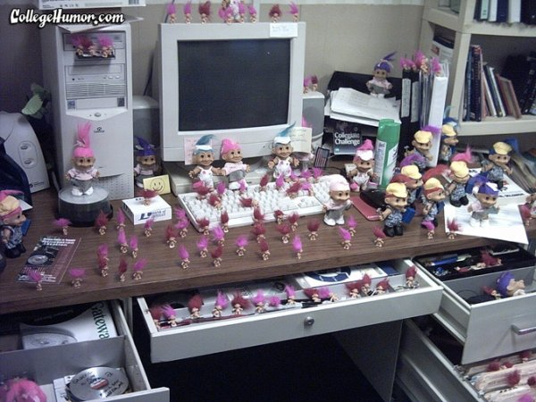 Desk full of pink troll dolls